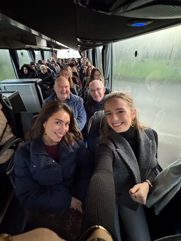 Young people and seniors on the coach on the way to the citytrip